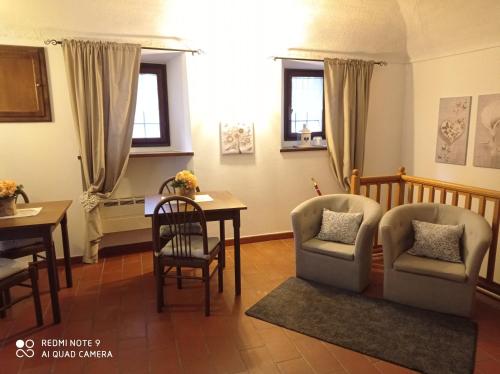 a living room with two chairs and a table at Mini hotel in Quincinetto