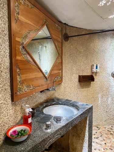 a bathroom with a sink and a mirror at Sapulidi Cafe, Gallery & Resort in Lembang