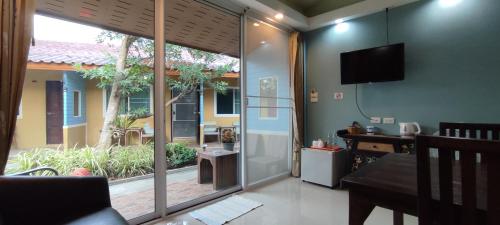 a living room with a sliding glass door to a patio at Q Zone Boutique House in Phra Nakhon Si Ayutthaya