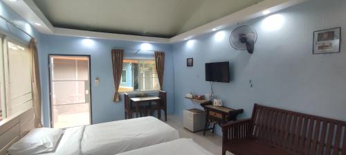 a bedroom with a bed and a desk and a television at Q Zone Boutique House in Phra Nakhon Si Ayutthaya