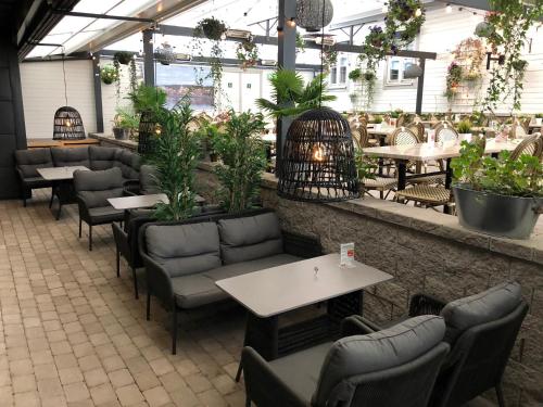 a restaurant with tables and chairs and a bird cage at Scandic Arvika in Arvika