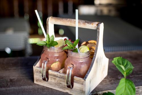 a wooden crate with two mason jars filled with food at Komfort Appartements Zirbenland - adults only - no dogs in Weißkirchen in Steiermark