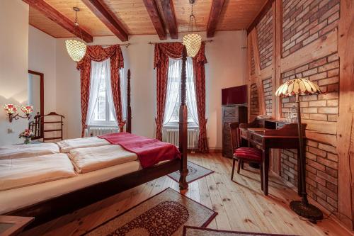 a bedroom with a bed and a desk in it at Jagdschloss Waldsee in Waldsee