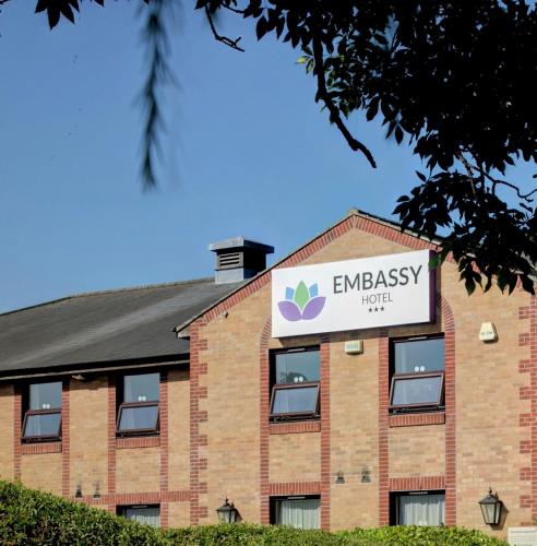 a sign on the side of a brick building at Embassy Hotel, Gateshead Newcastle, Sure Hotel Collection by Best Western in Newcastle upon Tyne