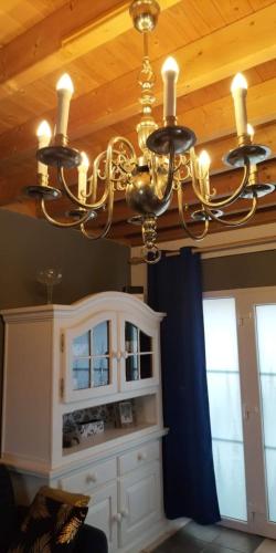 a chandelier hanging from a ceiling in a room at Gîte du Cheval Blanc à Houmont in Sainte-Ode