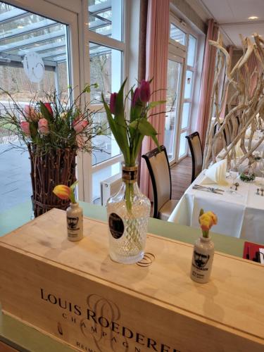 a vase filled with flowers sitting on top of a table at Land-gut-Hotel Waldesruh in Altenmedingen