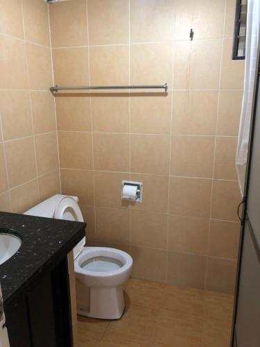 a bathroom with a toilet and a sink at Beach Resort Home Stay Batu Ferringhi 02 in Batu Ferringhi
