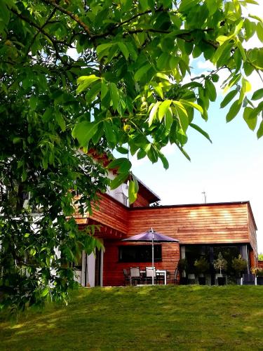 a red brick house with a table and an umbrella at Seeidylle Winkler in Bodensdorf