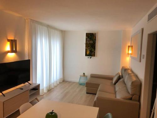 a living room with a couch and a flat screen tv at Apartamento Adrover - J in Sant Llorenç des Cardassar