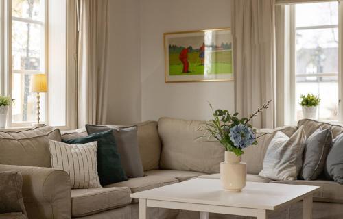 a living room with a couch and a table at Ekerum Resort Öland in Rälla
