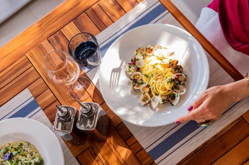 a person sitting at a table with a plate of food at Radisson Blu Resort & Spa in Split