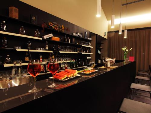 a bar with two glasses of wine on a counter at Casalgrande Hotel in Salvaterra