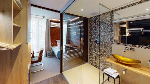 a bathroom with a glass shower with a banana on a counter at Das Wildeck Hotel & Restaurant in Abstatt