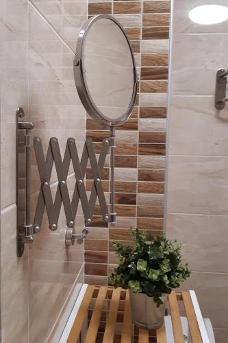 a bathroom with a mirror on a wall at Апартамент Адикт in Sozopol