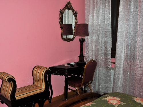 a room with a table and two chairs and a lamp at Agriturismo La Prosciutta in Faenza