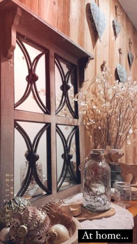 a window with a glass jar on a table at Le moulin de l Epine in Taintrux
