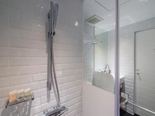 a bathroom with a shower with a glass door at Hotel Relax III in Taipei