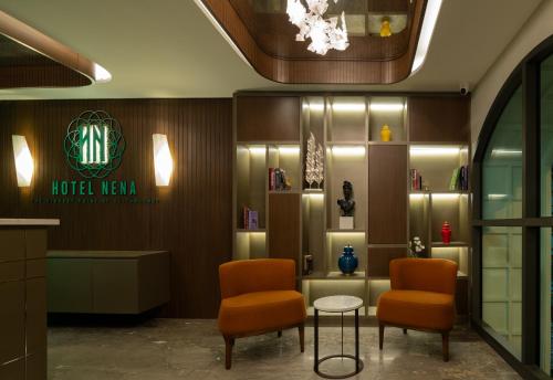 a lobby of a hotel with two chairs and a table at Hotel Nena in Istanbul