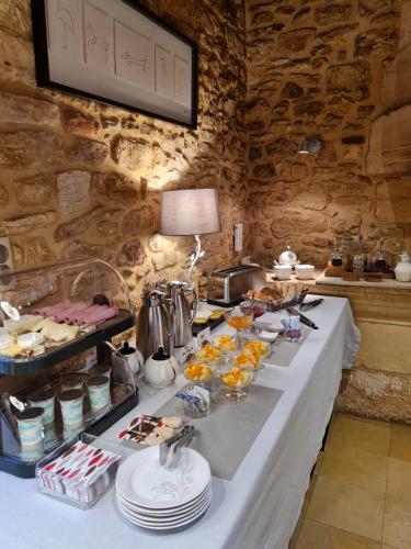 a buffet line with food on a table in a room at Le Clos de la Tour in Sainte-Nathalène