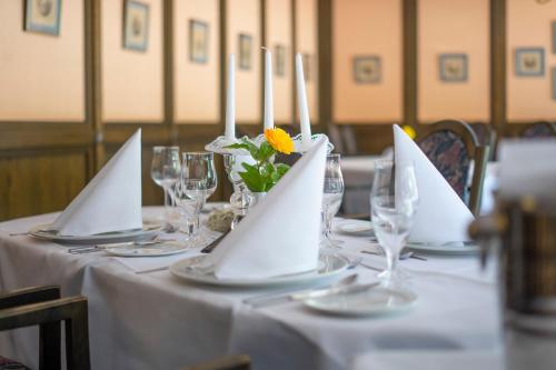 a table with white napkins and candles on it at Aspire Oldenburg, Trademark Collection by Wyndham in Oldenburg