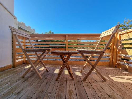 a wooden chair sitting on top of a deck at Coral Reefs Hotel Dahab in Dahab