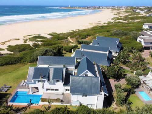an aerial view of a house on the beach at Beach Break Guest Houses and Villas in Cape St Francis
