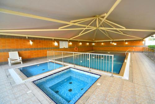 a large swimming pool in a building at Emirates Stars Hotel Apartments Dubai in Dubai