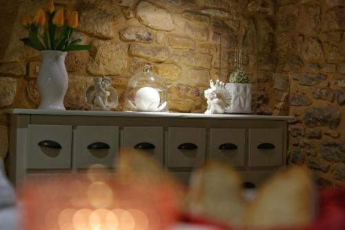a table with vases and flowers on top of it at Le Clos de la Tour in Sainte-Nathalène