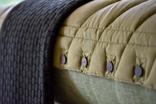 a close up of a mattress with buttons on it at Saseka Tented Camp in Hoedspruit
