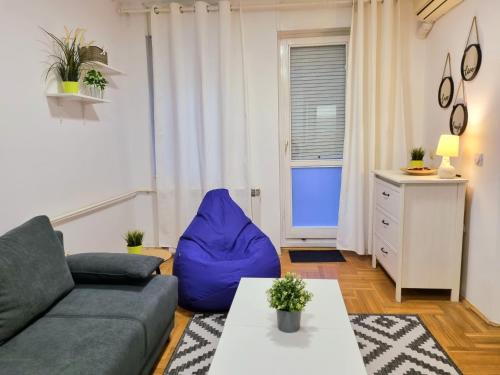 a living room with a couch and a table at Klara 23 in Tošin Bunar