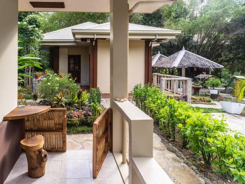 a porch of a house with a garden at Banamboo in Badian