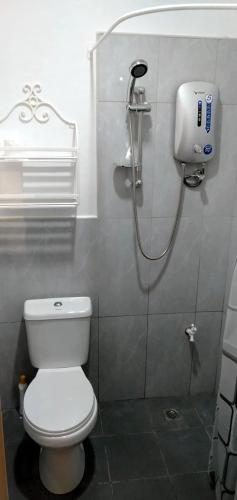 a bathroom with a white toilet and a shower at Banamboo in Badian