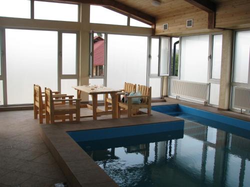 a house with a swimming pool and a table and chairs at Hotel Grant in Kharkiv