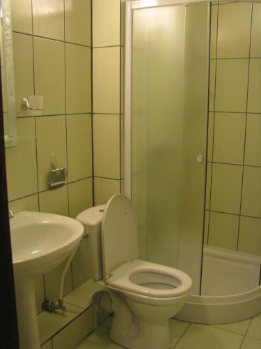 a bathroom with a toilet and a sink and a shower at Hotel Grant in Kharkiv