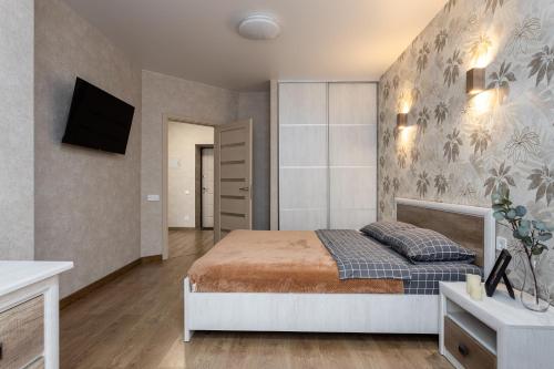 維什涅韋的住宿－0102 Sofia Residents apartment，一间卧室配有一张床,墙上配有电视