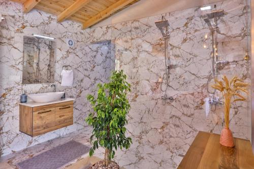 a bathroom with a sink and a marble wall at Flower Hotel Patara in Patara