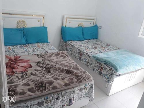 two beds sitting next to each other in a room at Nasr city Studio 2bedrooms 4beds in Cairo