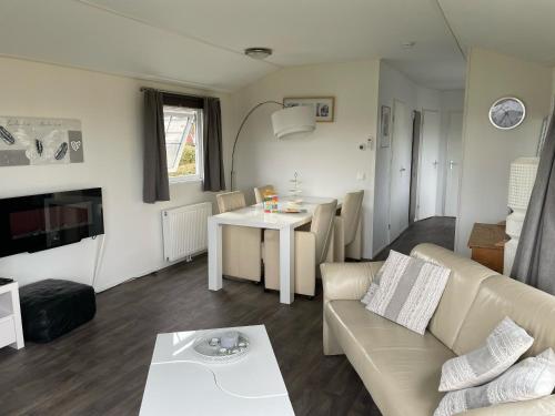 a living room with a couch and a table at Chalet 11 - Bergzicht Teuven in Teuven