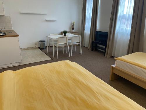 a hotel room with a table and chairs in a room at Hotel Koruna in Roudnice nad Labem