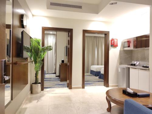 a kitchen and a living room with a table in a room at شقق كيان للشقق المخدومه in Jeddah