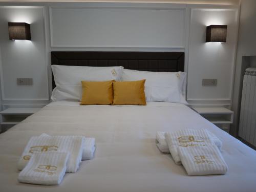 a large white bed with two pillows on it at Golden Residence in Caianello