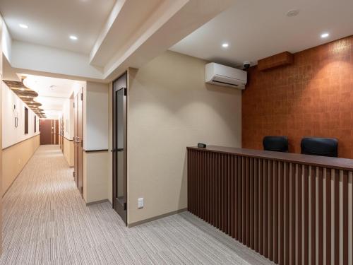 a corridor of a hospital hallway with a bar and chairs at West Japan Kyoto Kiyomizu in Kyoto