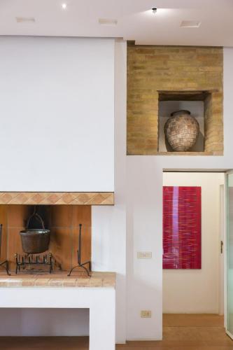 a kitchen with a counter with a stove top oven at Zafferano Rooftop Terrace Tower House in San Gimignano