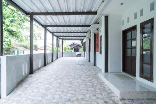 an empty corridor of a building with awning and a corridorngth at RedDoorz Plus near ITC Cempaka Mas 2 in Jakarta