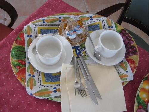 a table with two cups and plates on a table at Parlevan in Bangor