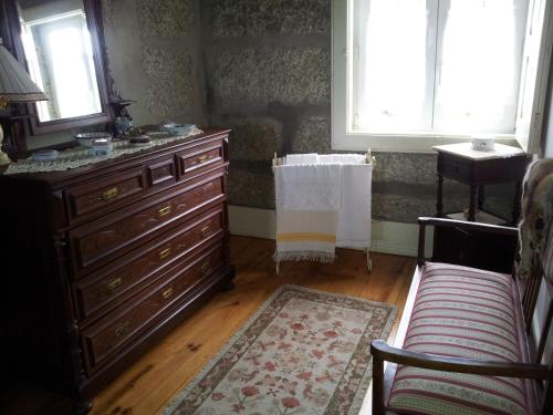 a living room with a dresser and a window at Casa Das Vendas in Vendas