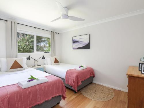 a bedroom with two beds and a window at Mountain Den in Blackheath