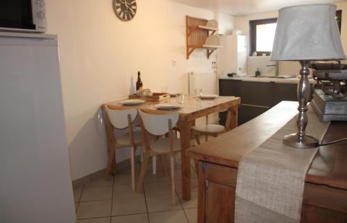 uma cozinha com uma mesa e cadeiras numa cozinha em La Belle Etap', gîte classé 3 étoiles em Étaples