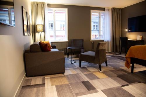 a living room with a couch and chairs in a hotel room at Best Western Plus JA Hotel Karlskrona in Karlskrona