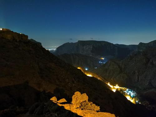 a view of the mountains at night at ROSES HOUSE OMAN in Jabal Al Akhdar